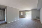 Located at 100 Conestoga Dr. in Marlton, NJ, this single-floor residence offers a well-organized layout designed for comfortable everyday living. The expansive living area is finished with plush wall-to-wall carpeting and neutral gray walls, creating a bright and open atmosphere. A sliding glass door provides direct access to an outdoor area, while an adjacent window invites natural light and views of surrounding greenery. The kitchen is thoughtfully equipped with warm wood cabinetry, dark granite-style countertops, tile flooring, and white appliances including a refrigerator, dishwasher, and range — providing ample storage and workspace. The bedrooms are generously sized, each featuring soft carpeting, neutral tones, and windows with blinds that allow for natural light. The primary bedroom stands out with a walk-in closet and an additional closet, offering abundant storage. The full bathroom is cleanly appointed with tile flooring, a tub-shower combination, a vanity, and ample wall space. Throughout the residence, clean white trim and a consistent neutral color palette contribute to a cohesive, move-in-ready aesthetic. This single-story home delivers a functional and comfortable living environment in a convenient Marlton location.