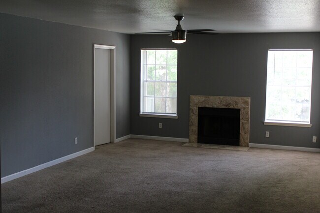 living area with fireplace - 9700 Leawood Blvd