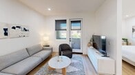 Located at 226 E High St in Moorpark, CA, this efficiently designed one-bedroom, one-bathroom single-level unit offers a clean, modern aesthetic throughout. Light wood-tone flooring flows seamlessly across every room, complementing the bright white walls and recessed lighting that keep the space feeling open and airy.

The kitchen is well-appointed with white shaker-style cabinetry, white subway tile backsplash, light quartz countertops, and a full suite of stainless steel LG appliances including a side-by-side refrigerator with water dispenser, gas range, over-the-range microwave, and dishwasher. The kitchen opens directly into the dining area, which transitions into a comfortable living room. The living room features a glass door with an adjacent window fitted with roller shades, allowing natural light while maintaining privacy.

A distinctive sliding barn door separates the bedroom from the main living area, adding a stylish architectural element. The bedroom is generously sized, featuring multiple windows with natural views, and includes a dedicated workspace nook. A closet and in-unit laundry provide practical storage and convenience.

The bathroom offers a clean, minimalist design with a white floating vanity, matte black fixtures, a large mirror, and a tub-shower combination. Every detail of this unit reflects a cohesive modern design sensibility.