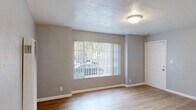 Located in Oakland, California, this single-story 2-bedroom, 1-bathroom home offers a practical and comfortable layout. The kitchen is well-equipped with warm honey-toned wood cabinetry, a black gas range, a full-size refrigerator, a built-in sink, and light ceramic tile flooring. A ceiling-mounted light fixture keeps the space bright and functional.

The two bedrooms feature light wood-look laminate flooring and soft gray walls, creating a calm, neutral atmosphere. Large windows dressed with vertical blinds invite natural light into both rooms, with one offering a view of the surrounding greenery. The spacious primary bedroom provides ample room for furnishings.

A dedicated walk-in closet with built-in shelving and hanging rods offers generous storage, complemented by a window that adds natural light. The full bathroom is clean and bright, featuring a tub and shower combo with a white surround, chrome fixtures, a window above for natural light, and a white vanity with sink and mirror.

A hallway connects the rooms, and the entry area features tile flooring and access to natural light. The home's straightforward, single-floor design ensures ease of movement throughout, making it a practical and inviting living space.