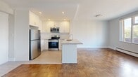 Located at 2303 Eglinton Ave E in Toronto, this well-appointed one-bedroom, one-bathroom unit offers a functional and comfortable layout across a single floor. The open-concept kitchen and living area serves as the heart of the unit, featuring classic parquet wood flooring that extends throughout. The kitchen is outfitted with white shaker-style cabinetry, stone-look countertops, a central island with a sink, and a full suite of stainless steel appliances including a refrigerator, range, microwave, and dishwasher. Recessed lighting illuminates the kitchen, while the living area benefits from large sliding glass doors that flood the space with natural light and provide direct access to a private balcony with outdoor views. The bedroom is a well-sized, quiet retreat featuring its own parquet flooring, a large window with natural views, and two closets offering generous storage. The bathroom is finished with white subway tile surrounding the tub-shower combo, a granite-topped vanity, and clean, modern fixtures. Baseboard heating is present throughout, ensuring year-round comfort in this neatly maintained Toronto residence.