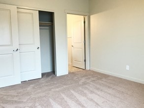 Claystone Dark Guest Bedroom - Stoneplace Apartment Homes
