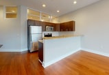 This contemporary 890 square foot apartment offers a well-designed living space with two bedrooms and two bathrooms. The open-concept layout seamlessly integrates the kitchen, living, and dining areas, creating a spacious feel. The kitchen boasts modern wood cabinetry, stainless steel appliances, and granite countertops, perfect for culinary enthusiasts.

The primary bedroom, measuring 160 square feet, provides a generous space for relaxation. Both bedrooms feature hardwood flooring and large windows, allowing natural light to flood the rooms. The bathrooms are outfitted with modern fixtures, including a glass-enclosed shower in one and a vanity with ample storage in the other.

Throughout the apartment, recessed lighting and large windows contribute to a bright, airy atmosphere. The living area showcases floor-to-ceiling windows, offering stunning views of the surrounding cityscape. High ceilings add to the sense of spaciousness.

Storage is thoughtfully incorporated with a dedicated closet space. The hallway connects all rooms efficiently, ensuring easy navigation through the apartment. The overall design embraces clean lines and a neutral color palette, providing a canvas for personal style while maintaining a modern, urban aesthetic.