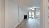 Located in Sun Valley Village in Altamonte Springs, FL, this one-bedroom, one-bathroom residence offers a well-organized single-floor layout with a comfortable and functional design throughout. The open-concept living and dining area is a standout feature, showcasing light wood-look flooring, a textured ceiling, and a ceiling fan. A tile-surround fireplace serves as a natural focal point, while sliding glass doors flood the space with natural light and provide outdoor access. The kitchen is efficiently designed in a galley style, featuring rich wood cabinetry, dark granite countertops, tile flooring, and black appliances including a range, microwave, and refrigerator. A dedicated laundry room offers side-by-side washer and dryer hookups along with built-in wire shelving for added storage convenience. The spacious bedroom includes light wood-look flooring, a ceiling fan, and a wide wall-to-wall closet with louvered bi-fold doors offering generous storage capacity. The full bathroom is appointed with a wood vanity, dark granite countertop, tile flooring, and a full-size tub-shower combination. Clean neutral tones and consistent finishes throughout give the space a cohesive and move-in-ready feel.
