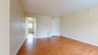 Located at 25284 Cottage Ave in Loma Linda, CA, this single-story, two-bedroom, one-bathroom home offers a practical and well-organized layout. The living room serves as the central gathering space, featuring warm wood-look laminate flooring, soft cream-toned walls, and a window that allows natural light to filter in, providing views of the surrounding greenery. The open feel of the room is complemented by clean white trim and a built-in wall vent for climate control.

The kitchen is outfitted with white cabinetry, open shelving, a dark speckled countertop, and white appliances including an electric range and dishwasher. Light ceramic tile flooring extends through the kitchen and dining area, creating a cohesive transition between spaces.

The primary bedroom features wood-look flooring, mirrored sliding closet doors, and a window with outdoor views. The second bedroom is finished with tile flooring and a large window offering natural light and garden views.

The bathroom includes a single-sink vanity with a granite-style countertop, white cabinetry with brushed nickel hardware, a full-size tub-shower combination, and tile flooring. Throughout the home, the neutral color palette and consistent finishes create a clean, functional living environment.