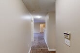 Located in Huntsville, Alabama, this single-story, 2-bedroom, 2-bathroom home offers a practical and comfortable layout. The interior features a neutral warm beige color palette with textured ceilings throughout, creating a consistent and cohesive aesthetic. Flooring transitions between wood-look vinyl in the wet areas and soft carpeting in the living and bedroom spaces.

The combined kitchen and dining area serves as the functional hub of the home, with warm wood-toned cabinetry and a layout that supports both cooking and casual dining. A dedicated laundry room adds everyday convenience. The hallway connects the main living areas to the private quarters, lined with multiple closets that provide ample storage throughout.

Both bedrooms are carpeted and feature ceiling fans with light fixtures, offering comfort year-round. Windows allow natural light to filter in, with views of the surrounding greenery. The spacious primary bedroom includes a walk-in closet for generous storage. Each bathroom is equipped with a full tub-shower combo, wood-look flooring, and clean, white fixtures. One bathroom also features a vanity with wood cabinetry and a light countertop. Overall, the home presents a functional, move-in-ready layout well-suited for a variety of lifestyles.