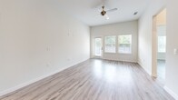 Located at 201 Wimberly St in Fort Worth, TX, this well-appointed 2-bedroom, 2-bathroom unit offers a thoughtfully designed open-concept layout. The kitchen is a standout feature, boasting crisp white cabinetry, a classic subway tile backsplash, granite countertops, a central island with a sink, and a full suite of stainless steel appliances including a refrigerator, range, microwave, and dishwasher. Elegant pendant lighting over the island adds a modern touch. The kitchen flows seamlessly into the living area, which features light wood-style flooring, soaring ceilings, a ceiling fan, and generous natural light from large windows and a glass door leading to the outdoors. Both bedrooms are bright and comfortably sized, each with ceiling fans, large windows, and the same cohesive wood-style flooring. The primary bedroom includes access to a spacious walk-in closet with built-in shelving and hanging rods. The primary bathroom is well-equipped with a granite-topped vanity, a deep soaking tub, a glass-enclosed walk-in shower with tile surround, and recessed lighting. The second bathroom features a frameless glass shower enclosure with neutral tile finishes. Throughout, the clean, neutral palette creates a bright and inviting atmosphere.