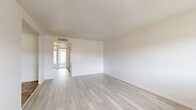 Located at 2035 Kings Hwy in Clearwater, Florida, this single-floor, one-bedroom, two-bathroom home offers a thoughtfully laid-out interior with a clean, bright aesthetic throughout. The open living area features light-toned wood-style flooring, crisp white walls, and a textured ceiling that adds character to the space. Natural light filters in through multiple windows, enhancing the airy feel of the main living and dining areas. The dining room connects seamlessly to the kitchen, which is outfitted with warm wood cabinetry, a double-basin stainless steel sink, light countertops, and tile flooring — a functional space with a practical, welcoming design. The bedroom is carpeted for comfort and includes multiple closet spaces with louvered doors, along with a ceiling fan and windows that bring in natural light. A standout feature of the home is the bathroom, which boasts dramatic marble-style wall surrounds encasing a soaking tub, creating a striking visual focal point. With seven closets distributed throughout, storage is abundant. The layout flows naturally from the living spaces to the private bedroom areas, making the home feel organized and spacious for its footprint.