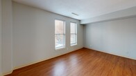 Located at 130 Dartmouth St in Boston's Back Bay neighborhood, this two-story, 3-bedroom, 2-bathroom home offers a functional and comfortable layout spread across two floors. Warm hardwood flooring runs consistently throughout, complemented by soft, neutral gray walls that create a clean and cohesive aesthetic.

The main floor provides a welcoming living area filled with natural light, along with a well-appointed kitchen featuring light maple cabinetry, granite-style countertops, stainless steel appliances including a gas range and built-in microwave, and a classic wood floor that ties the space together seamlessly.

The upper floor houses the generously sized primary bedroom, which benefits from multiple windows that allow ample natural light and views of the surrounding neighborhood. Two additional bedrooms offer versatile use, each with hardwood floors and neutral finishes. A full bathroom on this level includes a tub-shower combination with clean white surround. A second bathroom with a vanity and mirrored medicine cabinet provides added convenience.

The home also includes a combined bathroom and laundry room, a utility room, and an impressive five closets distributed throughout, ensuring abundant storage. A staircase with warm wood treads connects both levels. With its prime Back Bay location and practical multi-floor layout, this home is ideal for those seeking comfort in the heart of Boston.