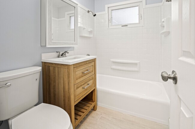 Brand new bathroom shower, vanity, toilet, medicine cabinet and tile floor - 1839 E Oklahoma Ave