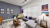 Located at 266 S Front St in the heart of Memphis, TN, this urban loft offers a thoughtfully designed one-bedroom, one-bathroom layout with a distinct industrial-chic aesthetic. Polished concrete floors run throughout, complemented by exposed ductwork and sleek track lighting that give the space a modern, loft-style character.

The entrance leads into a long, gallery-style hallway with crisp white walls and decorative accents, setting the tone for the rest of the unit. The open-concept kitchen and living area forms the heart of the home. The kitchen features rich wood cabinetry, granite countertops, stainless steel appliances, and a peninsula with bar seating — ideal for casual dining and entertaining. The living area is generously proportioned, bathed in natural light from large windows, and anchored by a bold accent wall in slate blue.

The bedroom offers a comfortable, well-sized retreat with polished concrete floors, clean white walls, and ample closet space. The bathroom is cleanly appointed with a tub-shower combination and granite vanity countertop. Additional functional spaces include a dedicated laundry room, pantry, and two closets. The overall ambiance is contemporary and efficient, blending urban industrial elements with warm, livable finishes.