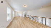 Located in Durham, NC, this three-story home offers a well-organized layout across three distinct floors. The entry-level garage provides ample parking and storage, housing the electrical panel and an automatic opener. The main living floor features an open, light-filled layout with light-toned hardwood-style flooring, neutral walls, and multiple windows that invite abundant natural light. A chandelier-lit dining area anchors the space, complemented by a modern kitchen outfitted with white shaker cabinetry, quartz countertops, and stainless steel Whirlpool appliances including a gas range, built-in microwave, and French door refrigerator. A dedicated laundry room with a full Whirlpool washer and dryer adds everyday convenience. The upper floor hosts three bedrooms, each with plush carpeting and closets. The generously sized primary bedroom includes an en-suite bath featuring a glass-enclosed tile shower and white vanity with quartz countertops. Additional bathrooms are finished with matching white cabinetry, quartz surfaces, and glass-door walk-in showers. An elegant staircase with wood railings and wrought iron balusters connects all three levels, reinforcing the home's clean, contemporary aesthetic throughout.
