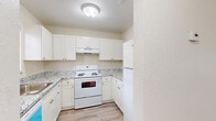 Located at 5925 Ceylon Ct in West Palm Beach, FL, this one-bedroom, one-bathroom unit offers a well-designed, efficiently utilized floor plan across a single level. Light-toned wood-look flooring runs throughout the space, lending a clean and cohesive aesthetic from room to room.

The living room is open and airy, benefiting from a large front-facing window that invites generous natural light. A hallway with a wall-mounted thermostat connects the main living area to the rest of the unit. The kitchen is outfitted with white shaker-style cabinetry, granite-look countertops, and white appliances including a range and refrigerator, all set atop the same wood-look flooring.

The bedroom offers a comfortable footprint with a window providing natural light and outdoor views, a dedicated closet with hanging rod, and neutral walls that complement the light flooring. The bathroom is well-appointed with a white vanity, granite-look countertop, a large mirror with overhead lighting, a window for natural light, and a tub-shower combination.

A textured ceiling is consistent throughout the unit, and the space also includes a private balcony, offering outdoor access. The overall ambiance is bright, clean, and move-in ready, making it a practical and inviting home in West Palm Beach.