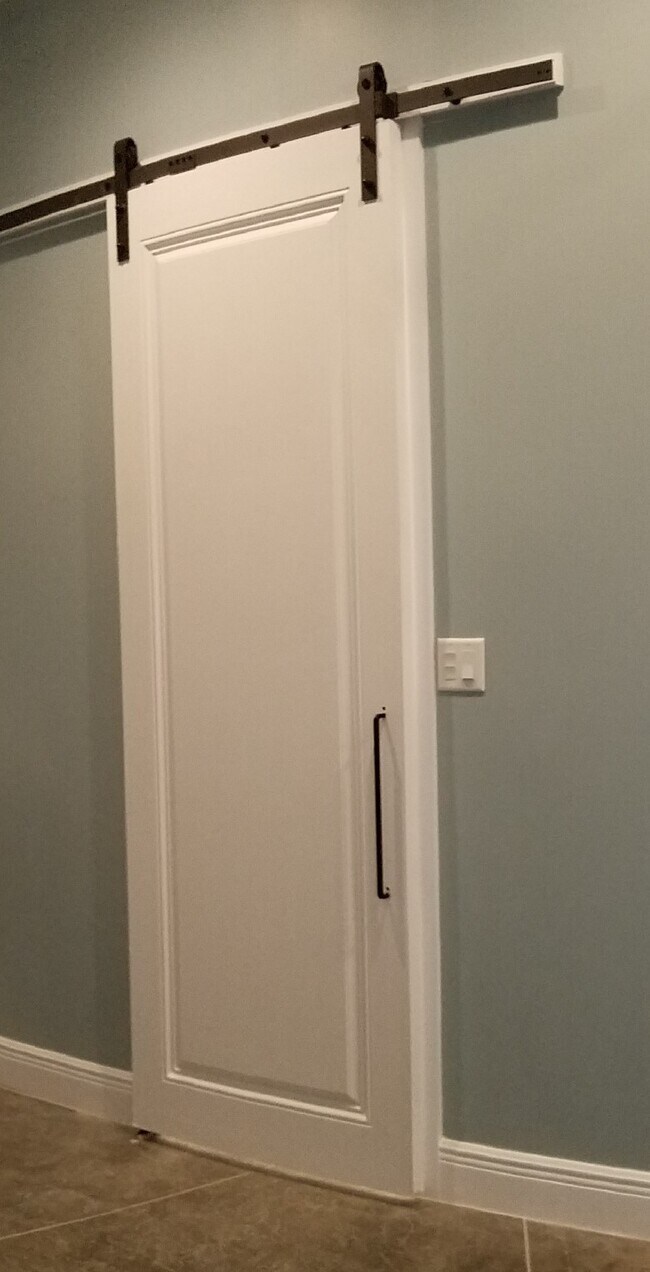 barn door to closet, bath and w/d - 22301 SW 182nd Ave