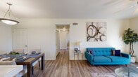 Located at 4262 W Figarden Dr in Fresno, CA, this two-bedroom, two-bathroom single-story unit offers a well-designed, functional layout across its thoughtfully arranged floor plan. The living room serves as the heart of the unit, featuring wood-look laminate flooring, a ceiling fan, and a sliding glass door that fills the space with natural light and provides direct access to a private patio. Adjacent to the living area, the dedicated dining space accommodates a full-sized dining table and is accented by a pendant light fixture overhead. The kitchen is outfitted with warm honey-toned wood cabinetry, tile countertops, white appliances including a range, microwave, dishwasher, and refrigerator, plus a window that brings in additional natural light. Both bedrooms are carpeted and equipped with ceiling fans, offering a comfortable, quiet retreat. The spacious primary bedroom includes a closet and connects to a bathroom featuring a single-sink vanity with wood cabinetry and a glass-enclosed shower. The second bathroom is similarly appointed with wood-look flooring and a glass-door shower enclosure. Two hallways connect the spaces efficiently, completing this well-organized and comfortable Fresno residence.