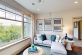 This thoughtfully designed 2-bedroom, 3-bathroom residence in Winston-Salem, NC offers a single-floor layout that maximizes comfort and functionality. The open-concept living and kitchen area serves as the heart of the home, where warm hardwood-style flooring, recessed lighting, and large windows frame lush greenery views, filling the space with natural light. A ceiling fan adds a practical touch to the airy living room.

The kitchen is well-equipped with white shaker cabinetry, dark granite countertops, stainless steel appliances, a peninsula with pendant lighting, and a double-basin sink — all flowing seamlessly into the dining and living areas. A dedicated laundry room accommodates a full-size GE washer and dryer side by side with overhead shelving for additional storage.

The generously sized primary bedroom features plush carpeting, a ceiling fan, and a wide window offering serene outdoor views. The second bedroom is equally comfortable with its own closet access and connectivity to the kitchen. All three bathrooms are clean and functional — one features a pedestal sink and wood-look flooring, while another includes a full tub-shower combination with white cabinetry. Two closets provide ample storage throughout the home.