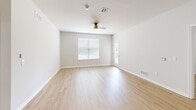 Located at 2895 Easton Avenue in Bethlehem, PA, this well-appointed single-floor home offers three bedrooms and two bathrooms with a clean, modern aesthetic. Light hardwood-style flooring runs throughout, complementing the crisp white walls and neutral tones that create a bright, cohesive atmosphere.

The open-concept kitchen and living area serves as the heart of the home. The kitchen is highlighted by a large center island with a white quartz countertop, undermount sink, and stylish pendant lighting. Dark shaker-style cabinetry with brushed nickel hardware pairs elegantly with stainless steel appliances, including a refrigerator, electric range, and microwave.

The living room is generously sized, featuring a ceiling fan, natural light from multiple windows, and a glass-panel door that leads directly to an outdoor area. The three bedrooms are well-proportioned, each with light-filled windows with blinds and light wood flooring. The primary bedroom includes a closet and direct access to a bathroom.

Both bathrooms are finished with the same dark cabinetry and white quartz countertops found in the kitchen, maintaining a consistent design language. One bathroom features a full tub/shower combo with brushed nickel fixtures, while the vanity bathrooms include large mirrors and undermount sinks. The overall design is modern, clean, and move-in ready.