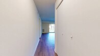 This well-appointed one-bedroom, one-bathroom unit at 5603 Crenshaw Rd in Richmond, Virginia offers a thoughtfully designed single-floor layout. A central hallway with sliding closet doors leads into the open combined living and dining area, which is finished with durable hardwood-style flooring and neutral walls that create a bright, clean atmosphere. A large sliding glass door fills the living space with natural light and provides views of the surrounding exterior. Ceiling fans are featured throughout, adding both functionality and comfort. The kitchen is efficiently designed with rich dark wood cabinetry, granite-patterned countertops, a gas range, a dishwasher, and a stainless steel sink beneath a window. The bedroom offers comfortable carpeted flooring, a ceiling fan, a natural light window with outdoor views, and generous closet space with built-in bifold doors. The unit includes three closets in total, providing ample storage throughout. The bathroom is finished with a full tub-shower combination and a dark wood vanity with a white countertop. Clean white walls and consistent finishes throughout give the unit a cohesive, move-in-ready feel.