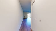 This well-appointed one-bedroom, one-bathroom unit at 5603 Crenshaw Rd in Richmond, Virginia offers a thoughtfully designed single-floor layout. A central hallway with sliding closet doors leads into the open combined living and dining area, which is finished with durable hardwood-style flooring and neutral walls that create a bright, clean atmosphere. A large sliding glass door fills the living space with natural light and provides views of the surrounding exterior. Ceiling fans are featured throughout, adding both functionality and comfort. The kitchen is efficiently designed with rich dark wood cabinetry, granite-patterned countertops, a gas range, a dishwasher, and a stainless steel sink beneath a window. The bedroom offers comfortable carpeted flooring, a ceiling fan, a natural light window with outdoor views, and generous closet space with built-in bifold doors. The unit includes three closets in total, providing ample storage throughout. The bathroom is finished with a full tub-shower combination and a dark wood vanity with a white countertop. Clean white walls and consistent finishes throughout give the unit a cohesive, move-in-ready feel.