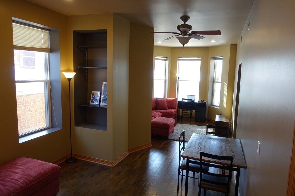 Dining room and Living room featuring sunny bay window. - 3553 S Hermitage Ave