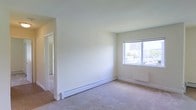 Located at 124 N North Carolina Ave in Atlantic City, New Jersey, this single-floor unit offers a clean, functional layout with a calm and neutral aesthetic throughout. The living area is finished with soft wall-to-wall carpeting and crisp white walls, creating a bright and welcoming atmosphere. A large window allows generous natural light to fill the room while offering views of the surrounding Atlantic City skyline and neighborhood. Baseboard heating runs along the walls, ensuring year-round comfort. The open corridor connects seamlessly to additional rooms, suggesting a practical and efficient floor plan. The overall design is understated and move-in ready, with a light color palette that makes the space feel airy and open. The unit's single-floor layout provides ease of accessibility, while its Atlantic City location places it within close proximity to the city's many amenities, entertainment venues, and the iconic boardwalk. Whether used as a primary residence or investment property, this unit offers a solid foundation of functional living space in a well-known coastal New Jersey destination.