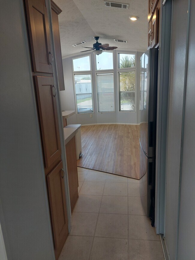 Living area. Kitchen on left fridge and storage to right - 1475 Flamingo Dr