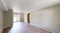 Located at 1750 Melville Dr in Rochester Hills, Michigan, this 2-bedroom, 1-bathroom single-story home offers a well-organized layout designed for comfortable everyday living. The living room is bright and open, featuring light-toned hardwood-style flooring, neutral beige walls, a ceiling fan, and a sliding glass door that opens to a private patio with outdoor views. The adjacent dining room flows naturally from the living space, creating a cohesive common area. The kitchen is efficiently appointed with rich dark wood cabinetry, light stone-finish countertops, a double stainless steel sink, and stainless steel appliances including a range and over-the-range microwave. A pantry provides additional storage convenience. Both bedrooms are carpeted in warm neutral tones and include dedicated closet space — the primary bedroom features two closets for generous storage capacity. The second bedroom benefits from a bright window with natural light. The full bathroom includes a tub/shower combination with tile surround, a wood-tone vanity, and light wood-style flooring. Additional highlights include a hallway connecting the main spaces, an in-unit laundry area, and four closets throughout the home, ensuring practical storage solutions.
