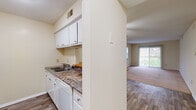 Located at 2522 Suffolk Ave in High Point, NC, this single-floor home offers a practical and comfortable layout across three bedrooms and two bathrooms. The kitchen features white cabinetry, dark countertops, a double-basin sink, and a dishwasher, and opens directly toward the living area through a half-wall partition. Wood-look flooring runs through the kitchen and connecting spaces, while soft carpet covers the living room and bedrooms, adding warmth throughout. The living room is a generous, open space filled with natural light from a large sliding glass door that offers outdoor views, making it an inviting area for relaxing or entertaining. The bedrooms are well-proportioned, with the primary bedroom offering a comfortable footprint, a ceiling fan, a window with natural light, and access to a closet with built-in shelving. Additional bedrooms share the carpeted flooring and maintain a clean, neutral palette. The two bathrooms include a tiled tub-shower combination with full wall tile surround, and a separate water closet. Two hallways connect the rooms efficiently, and a dedicated closet provides added storage. Textured ceilings are present throughout, and the overall color scheme of neutral creams and beiges creates a clean, move-in-ready ambiance.