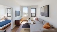 This single-floor residence showcases a clean, modern design with a cohesive aesthetic carried throughout every room. The open-concept living area is anchored by a comfortable sectional sofa, warm wood-tone flooring, and large windows that flood the space with natural light and offer sweeping urban views. A wall-mounted television and a sleek media console with a marble top complete the living space, creating a functional yet stylish environment.

The kitchen is well-appointed with floor-to-ceiling light gray cabinetry, dark countertops, and a full suite of stainless steel appliances including a refrigerator, range, microwave, and dishwasher. A in-unit washer is also integrated into the kitchen area. A compact dining island with bar stools provides a casual dining option, making the kitchen both practical and inviting.

The bedrooms maintain the residence's minimal, contemporary feel with light-toned walls, wood flooring, and ample natural light from well-placed windows that frame city views. Mirrored sliding closet doors add depth and functionality to the sleeping quarters.

The bathroom is finished in crisp white, featuring a soaking tub and shower combination, a wide vanity with an undermount sink, and clean tile flooring — delivering a neat, spa-like quality.