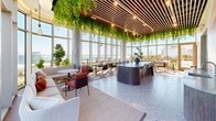 Located at 33 Westchester Place in New Rochelle, NY, this generously sized amenity floor offers a thoughtfully designed collection of indoor and outdoor spaces that blend contemporary architecture with lush natural elements. The centerpiece of the interior is a dramatic lounge and dining area characterized by floor-to-ceiling glass walls that flood the space with natural light and frame breathtaking views of the Long Island Sound. A striking wood-slat ceiling is adorned with cascading greenery and ambient pendant lighting, creating a warm, biophilic atmosphere. Terrazzo flooring throughout ties the interior together with a polished, modern aesthetic. A curved, dark-wood bar island provides a social focal point, complemented by a mix of lounge seating and dining arrangements. A dedicated wellness room features vibrant, large-scale mural artwork in flowing warm tones, a utility island, and open floor space ideal for yoga or fitness activities. The expansive rooftop terrace is a standout feature, offering multiple zones including a wood deck with panoramic water views, turf lawn areas, tiled outdoor kitchen and grilling stations, raised planter beds with seasonal flora, teak lounge chairs, a pet-friendly fenced enclosure, and glass-panel railings that preserve unobstructed views of the surrounding skyline and waterfront.