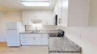 Located at 2500 Soquel Dr in Santa Cruz, CA, this 2-bedroom, 1-bathroom home offers a thoughtfully designed single-floor layout with contemporary updates throughout. The kitchen is a standout feature, showcasing crisp white shaker cabinets, granite-look countertops, a skylight that floods the space with natural light, and stainless steel appliances including a range, microwave, and refrigerator. Light-toned hardwood-style flooring runs throughout, creating a cohesive and airy feel across all rooms. The living room opens directly to a private balcony via sliding glass doors, offering pleasant outdoor views and ample natural light. Both bedrooms are well-sized, with the primary bedroom providing generous proportions and large sliding-door closets for abundant storage. A third closet adds additional storage convenience. The bathroom features a full tub-shower combo with clean white tile surround, complemented by warm neutral walls and wood-style flooring. A dedicated dining room and hallway complete the functional layout. Ceiling fans and baseboard heating provide year-round comfort. The overall ambiance is clean, bright, and move-in ready, making this Santa Cruz home a practical and inviting space.