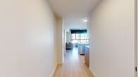 Located at 101 Church Ave in College Station, TX, this modern 4-bedroom, 3-bathroom unit offers a well-designed single-floor layout with contemporary finishes throughout. Light wood-tone flooring flows seamlessly across the living, kitchen, and bedroom spaces, creating a clean, cohesive aesthetic.

The living room is a bright, welcoming space anchored by large floor-to-ceiling windows that invite abundant natural light and offer open urban views of the surrounding cityscape. Exposed concrete ceilings add an industrial character balanced by crisp white walls and modern furnishings.

The kitchen is thoughtfully appointed with granite countertops, a large island with bar seating, stainless steel appliances including a refrigerator, range, and microwave, as well as white upper cabinetry and warm wood-toned lower cabinets with a subway tile backsplash.

Each of the four bedrooms is efficiently arranged, with built-in storage options and windows providing natural light and city views. Ceiling fans are featured in the bedrooms, enhancing comfort. The primary bedroom offers a comfortable and functional private retreat.

The three bathrooms maintain the unit's modern aesthetic, featuring white tile walk-in showers with glass doors, granite vanity tops, white cabinetry, and light wood flooring. A hallway connects the rooms, contributing to a practical and organized floor plan throughout.