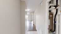 Located at 1020 Paisley Rd in Guelph, Ontario, this well-appointed one-bedroom, one-bathroom unit offers a thoughtfully designed single-floor layout. The open-concept kitchen and living area serves as the heart of the space, featuring white shaker-style cabinetry, taupe countertops, stainless steel appliances including a refrigerator, electric range, and over-the-range microwave, as well as a double stainless steel sink. Light tile flooring runs throughout the kitchen, complementing the clean, bright aesthetic. The bedroom is a comfortable size, finished with warm grey laminate hardwood flooring, neutral toned walls, and a mirrored sliding closet. Large windows and a sliding glass door open to a private balcony, offering elevated views of the surrounding Guelph neighbourhood. The four-piece bathroom includes a full soaker tub and shower combination with tile flooring. A dedicated in-suite laundry room is equipped with a full-size washer and dryer, tile flooring, and built-in wire shelving for additional storage. Neutral tones, clean lines, and laminate hardwood flooring in the living areas create a cohesive, modern ambiance throughout the unit.