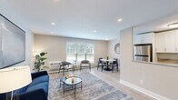Located at 1300 Fayette St in Conshohocken, PA, this one-bedroom, one-bathroom residence offers a thoughtfully arranged single-floor layout. The open living room features light hardwood-style flooring, recessed lighting, and large windows with blinds that invite generous natural light and views of surrounding greenery. The space flows into a well-appointed kitchen outfitted with white shaker cabinetry extending to the ceiling, striking marble-look granite countertops, stainless steel appliances, and a classic subway-style backsplash — all set over matching hardwood-style floors. The bedroom is a comfortable retreat with soft carpeting, a ceiling fan with light fixture, and a large window overlooking lush outdoor scenery. The room offers ample space for a full furniture arrangement. The bathroom is clean and contemporary, featuring a full soaking tub and shower combo with large-format neutral tile surround and chrome fixtures. A hallway connects the spaces efficiently, providing closet storage and a welcoming entry. Neutral tones throughout create a cohesive and calming ambiance, making this residence a polished and functional home in a desirable Pennsylvania location.