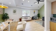 Located at 2109 Oglethorpe Circle in Pooler, Georgia, this single-floor amenity space offers a thoughtfully designed layout comprising an exercise room, a living room lounge, and a private office. Throughout the space, light hardwood flooring, crisp white walls, and recessed lighting create a clean, contemporary aesthetic.

The expansive exercise room is the centerpiece of the facility, bathed in natural light from floor-to-ceiling windows and glass doors that offer views of an outdoor pool area. The gym is outfitted with a full array of cardio equipment including treadmills and ellipticals, as well as a strength training station, free weights, benches, and exercise mats. Large wall mirrors and a dedicated storage room enhance the functionality of this well-appointed fitness space.

The living room lounge features a vaulted ceiling with a ceiling fan, an accent wall painted in a warm sage green, and light-filled windows. Comfortable seating, a flat-screen TV, and a small refreshment station make it an inviting gathering area.

The private office is elegantly finished with a coffered accent wall, open shelving, and ample desk workspace. Natural light from multiple windows and a glass-paned door keeps the room bright and professional. A bright entryway corridor with linear pendant lighting connects the spaces and leads to the exterior.
