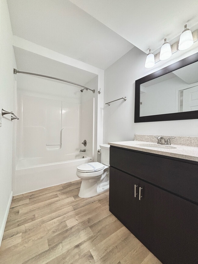 Quartz Countertop/framed mirror - Keystone Lake Apartments