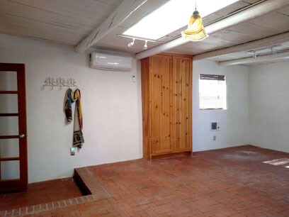Living room with kitchen door at left - 11 Camino de las Brisas