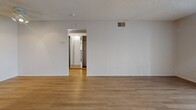 Located at 12700 Bloomfield Ave in Norwalk, CA, this single-story, one-bedroom, one-bathroom unit offers a well-organized layout across a comfortable footprint. Light wood-look flooring flows seamlessly throughout all rooms, creating a clean and cohesive aesthetic.

The living room is bright and open, featuring a textured ceiling, a large sliding glass door with vertical blinds that fills the space with natural light and leads out to a private patio with an outdoor view. The adjacent dining area connects naturally to the kitchen, which is equipped with warm honey-toned cabinetry, a gas range, a full-size refrigerator, a built-in microwave, and a peninsula with counter seating. A skylight-style ceiling fixture brightens the kitchen workspace.

The bedroom is a well-proportioned room with a window that allows natural light in, a textured ceiling, and access to a hallway with two closets providing ample storage. In-unit laundry adds everyday convenience. The bathroom features a white vanity with under-sink storage, a large mirror, and a shower-tub combination with clean, neutral finishes throughout. The hallway connects all areas of the unit efficiently, completing a practical and comfortable single-floor layout.