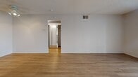 Located at 12700 Bloomfield Ave in Norwalk, CA, this single-story, one-bedroom, one-bathroom unit offers a well-organized layout across a comfortable footprint. Light wood-look flooring flows seamlessly throughout all rooms, creating a clean and cohesive aesthetic.

The living room is bright and open, featuring a textured ceiling, a large sliding glass door with vertical blinds that fills the space with natural light and leads out to a private patio with an outdoor view. The adjacent dining area connects naturally to the kitchen, which is equipped with warm honey-toned cabinetry, a gas range, a full-size refrigerator, a built-in microwave, and a peninsula with counter seating. A skylight-style ceiling fixture brightens the kitchen workspace.

The bedroom is a well-proportioned room with a window that allows natural light in, a textured ceiling, and access to a hallway with two closets providing ample storage. In-unit laundry adds everyday convenience. The bathroom features a white vanity with under-sink storage, a large mirror, and a shower-tub combination with clean, neutral finishes throughout. The hallway connects all areas of the unit efficiently, completing a practical and comfortable single-floor layout.