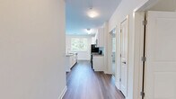 Located at 1 Glover Ave in Norwalk, CT, this well-appointed 3-bedroom, 2-bathroom residence offers generous single-floor living with a thoughtfully designed layout. The open-concept kitchen and living area serves as the heart of the home, featuring rich wood-look flooring, white shaker cabinetry, granite countertops, a large center island with a sink, and a full suite of stainless steel appliances. Natural light pours in through multiple windows, and sliding glass doors lead to a private balcony overlooking a lush, tree-lined landscape.

The spacious primary bedroom is bathed in natural light from dual windows framing greenery views, complemented by wood-look flooring and a generous walk-in closet with wire shelving. The additional bedrooms are carpeted and bright, each offering pleasant outdoor views. Both bathrooms are finished with light tile flooring, white vanities, and clean, neutral tones — one featuring a well-lit vanity mirror with overhead lighting. A dedicated walk-in closet provides ample storage. The overall ambiance of the residence is clean, modern, and airy, with a neutral palette throughout that creates a calm and versatile living environment.