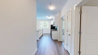 Located at 1 Glover Ave in Norwalk, CT, this well-appointed 3-bedroom, 2-bathroom residence offers generous single-floor living with a thoughtfully designed layout. The open-concept kitchen and living area serves as the heart of the home, featuring rich wood-look flooring, white shaker cabinetry, granite countertops, a large center island with a sink, and a full suite of stainless steel appliances. Natural light pours in through multiple windows, and sliding glass doors lead to a private balcony overlooking a lush, tree-lined landscape.

The spacious primary bedroom is bathed in natural light from dual windows framing greenery views, complemented by wood-look flooring and a generous walk-in closet with wire shelving. The additional bedrooms are carpeted and bright, each offering pleasant outdoor views. Both bathrooms are finished with light tile flooring, white vanities, and clean, neutral tones — one featuring a well-lit vanity mirror with overhead lighting. A dedicated walk-in closet provides ample storage. The overall ambiance of the residence is clean, modern, and airy, with a neutral palette throughout that creates a calm and versatile living environment.