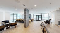 Located at 800 Van Cliburn Way in Fort Worth, Texas, this elegantly appointed clubroom offers a generously sized, single-floor amenity space designed for both social gatherings and relaxed lounging. The interior is anchored by a striking herringbone-patterned hardwood floor that flows throughout, complemented by crisp white ceilings with recessed and pendant lighting, including a dramatic ring chandelier that serves as a focal point above the central lounge area.

A bold textured brick column divides the open-plan layout, creating natural zones within the space. The main lounge features plush sectional and accent seating arranged around a glass coffee table, while a secondary lounge area showcases intimate booth-style banquettes set against richly tiled copper-toned accent walls, illuminated by pendant lights. Dark velvet lounge chairs and sculptural furniture add depth and sophistication throughout.

A fully equipped kitchenette includes stone countertops, dark cabinetry, a built-in oven, and dual wall-mounted televisions backed by polished marble tile. A long communal dining table with a sculptural centerpiece anchors an adjacent gathering area. Floor-to-ceiling windows on multiple walls flood the space with natural light and offer views of the surrounding outdoor patio and community terrace, accessible through a set of full-glass French doors.