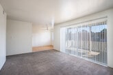 Located at 31108 Brae Burn Ave in Hayward, CA, this single-floor, 2-bedroom, 2-bathroom home offers a well-organized layout designed for comfortable everyday living. The galley-style kitchen features white cabinetry extending to the ceiling for generous storage, stone-look countertops, a full suite of appliances including a refrigerator and range, and light hardwood flooring that adds warmth to the space. Adjacent to the kitchen, the dining area flows naturally into the living room, which is carpeted and filled with natural light through a large sliding glass door fitted with vertical blinds. The slider opens directly onto a private balcony with exterior views of the neighborhood. Both bedrooms are carpeted and bright, with the spacious primary bedroom offering a well-proportioned layout and access to its own bathroom. The primary bathroom includes a wide vanity with dual sinks, stone-look countertops, white cabinetry, a large mirror, and wood-look flooring. The second bathroom is clean and functional, featuring a bathtub, window for natural light, and hardwood-style flooring. Throughout the home, four closets provide ample storage, complemented by a dedicated utility room. The neutral color palette and clean finishes create a bright, move-in-ready atmosphere.