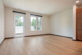 Located at 242 Dunning St in Madison, WI, this one-bedroom, one-bathroom unit offers a thoughtfully designed layout across a single floor. The open-concept living and kitchen area serves as the heart of the space, featuring light hardwood flooring throughout that creates a warm, cohesive feel. The kitchen is well-appointed with warm-toned wood cabinetry, stainless steel appliances including a refrigerator, gas range, microwave, and dishwasher, complemented by white quartz countertops and a subtle tile backsplash. Recessed lighting and a contemporary pendant fixture illuminate the space, while a freestanding kitchen island adds additional prep and storage space. Large windows and a glass patio door flood the living area with natural light and provide direct access to a private patio with black metal railings overlooking the surrounding neighborhood. The bedroom is a comfortable, well-lit retreat featuring a ceiling fan and a sizable window with green outdoor views. Two closets provide ample storage throughout the unit. The bathroom offers a clean, modern finish, and a dedicated laundry area adds everyday convenience. This unit combines modern finishes with a practical, livable layout in a residential Madison neighborhood.