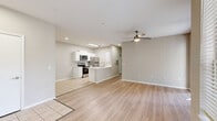 Located at 2150 Lake Highland Blvd in Lakeland, FL, this single-story, 3-bedroom, 2-bathroom home offers a well-designed layout with a bright, open feel throughout. The living room features light hardwood-style flooring, a ceiling fan, and sliding glass doors that open to a private patio, flooding the space with natural light and providing views of lush outdoor greenery. A large window further enhances the airy atmosphere.

The kitchen and dining area flow seamlessly together in an open-concept arrangement. The kitchen is outfitted with white cabinetry, stainless steel appliances including a range, microwave, and refrigerator, and light tile flooring that extends through the space.

The three bedrooms are carpeted for comfort, each featuring ceiling fans and windows with natural light. The primary bedroom is generously sized and includes closet space. The additional bedrooms offer solid proportions suitable for various uses. A total of seven closets throughout the home ensures ample storage.

Both bathrooms are finished with light tile flooring and white vanities with brushed nickel fixtures. One bathroom features a full soaking tub. A dedicated laundry room with wire shelving and utility hookups adds everyday convenience. The single-floor layout ensures easy accessibility throughout the home.