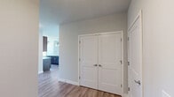 Located at Watermark Terrace in Elgin, Illinois, this well-appointed 2-bedroom, 2-bathroom residence offers a thoughtfully designed open-concept layout with modern finishes throughout. The combined kitchen and living area serves as the heart of the home, featuring light wood-look flooring, rich dark cabinetry, quartz countertops, a large center island, stainless steel appliances, and a classic subway tile backsplash. Pendant lighting over the island adds a refined touch. A large window in the kitchen frames a stunning waterfront view, while sliding glass doors in the living area open to a private balcony overlooking lush greenery — ideal for enjoying the outdoors. The spacious primary bedroom is a generously sized retreat, and both bedrooms feature plush carpeting. The second bedroom includes a closet and a window with scenic outdoor views. The primary bathroom is finished with a dual-sink vanity, dark cabinetry, light tile flooring, and direct access to a closet. The second bathroom offers a tiled tub-shower combination with clean white tile and a wood-toned vanity. The overall aesthetic is clean, contemporary, and bright, with neutral tones and quality materials creating a comfortable, move-in-ready living environment.