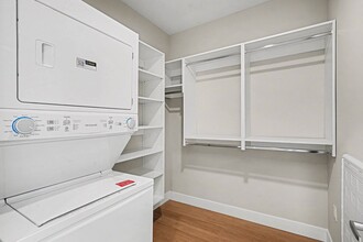 Uncover the convenience of in-unit laundry at Trail House Apartments. This spacious laundry room features ample storage, making your daily routines seamless. Elevate your living experience—schedule your tour today! - Trail House Apartments