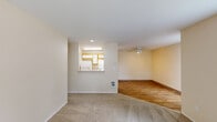 Located at 4900 SW Greensboro Way in Beaverton, Oregon, this single-floor, 2-bedroom, 3-bathroom home offers a practical and comfortable layout across a well-utilized footprint. The entrance welcomes you with wood-style flooring that flows into the living and dining areas. The living room is bright and open, featuring a ceiling fan and direct access to a private patio through a sliding glass door with vertical blinds, offering pleasant outdoor views. A pass-through window connects the living area to the kitchen, which includes wood-toned cabinetry and white appliances, keeping the layout social and connected. The dining area sits adjacent, completing a cohesive common living space. Both bedrooms are carpeted and filled with natural light from large windows dressed with vertical blinds, and each is served by baseboard heating. The primary bedroom offers a generous footprint with access to the hallway and closet. Three bathrooms, featuring tub-shower combinations with brushed nickel fixtures and wood-style flooring, provide ample convenience. Three closets offer plentiful storage throughout. A dedicated laundry room adds everyday practicality to complete this well-appointed Beaverton home.