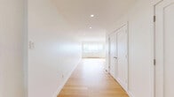 This contemporary 950 square foot apartment in Montreal offers a harmonious blend of style and functionality. The open-concept design maximizes space, seamlessly integrating the kitchen, living, and dining areas. The kitchen is a standout feature, boasting sleek white cabinetry, a large central island, and high-end stainless steel appliances, including a hood fan and built-in oven.

Floor-to-ceiling windows flood the space with natural light and provide breathtaking panoramic views of the Montreal cityscape and surrounding architecture. The living area is spacious and versatile, with warm hardwood flooring that extends throughout the apartment, creating a cohesive and inviting atmosphere.

The bathroom is modern and minimalist, featuring clean lines and a neutral color palette. Built-in storage solutions, including a laundry area, maximize the apartment's efficiency. Recessed lighting and pendant fixtures add to the contemporary ambiance.

This well-designed space offers a perfect balance of urban sophistication and comfortable living, ideal for those seeking a stylish home in the heart of Montreal.