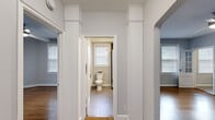 Located at 200 Rhode Island Ave NE in Washington, DC, this well-appointed one-bedroom, one-bathroom unit offers a thoughtfully designed layout across a single floor. Rich hardwood flooring flows throughout the living room, hallway, and bedroom, lending warmth and continuity to the space.

The living room is bright and open, benefiting from multiple windows that invite natural light. A ceiling fan adds comfort, and a wall-mounted AC unit ensures year-round climate control. A charming pass-through window connects the living area to the kitchen, enhancing the sense of openness.

The kitchen is efficiently laid out with dark espresso cabinetry, granite countertops, a classic white subway tile backsplash, and a full suite of stainless steel appliances including a range, microwave, and dishwasher. Light tile flooring and a window complete the space.

The bedroom is comfortably sized, featuring hardwood floors, a ceiling fan, and natural light from double windows. It is served by a dedicated closet with built-in shelving. The hallway, framed by elegant decorative columns and arched doorways, connects all rooms seamlessly.

The bathroom includes a standalone glass-enclosed shower, granite vanity, and a bright window for natural ventilation.